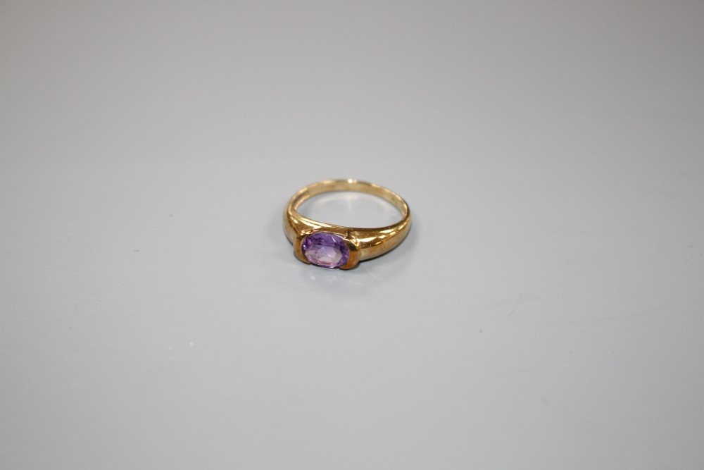 A modern 9ct gold and oval cut amethyst set ring, size P, gross weight 2.3 grams.